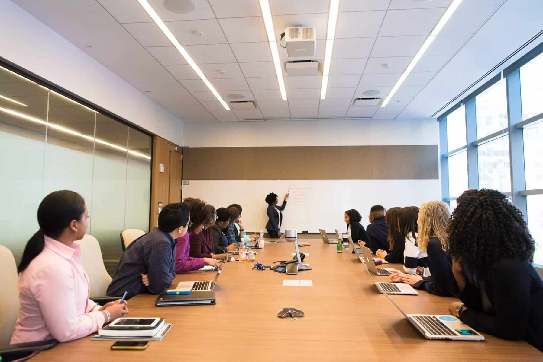 People attending board room meeting