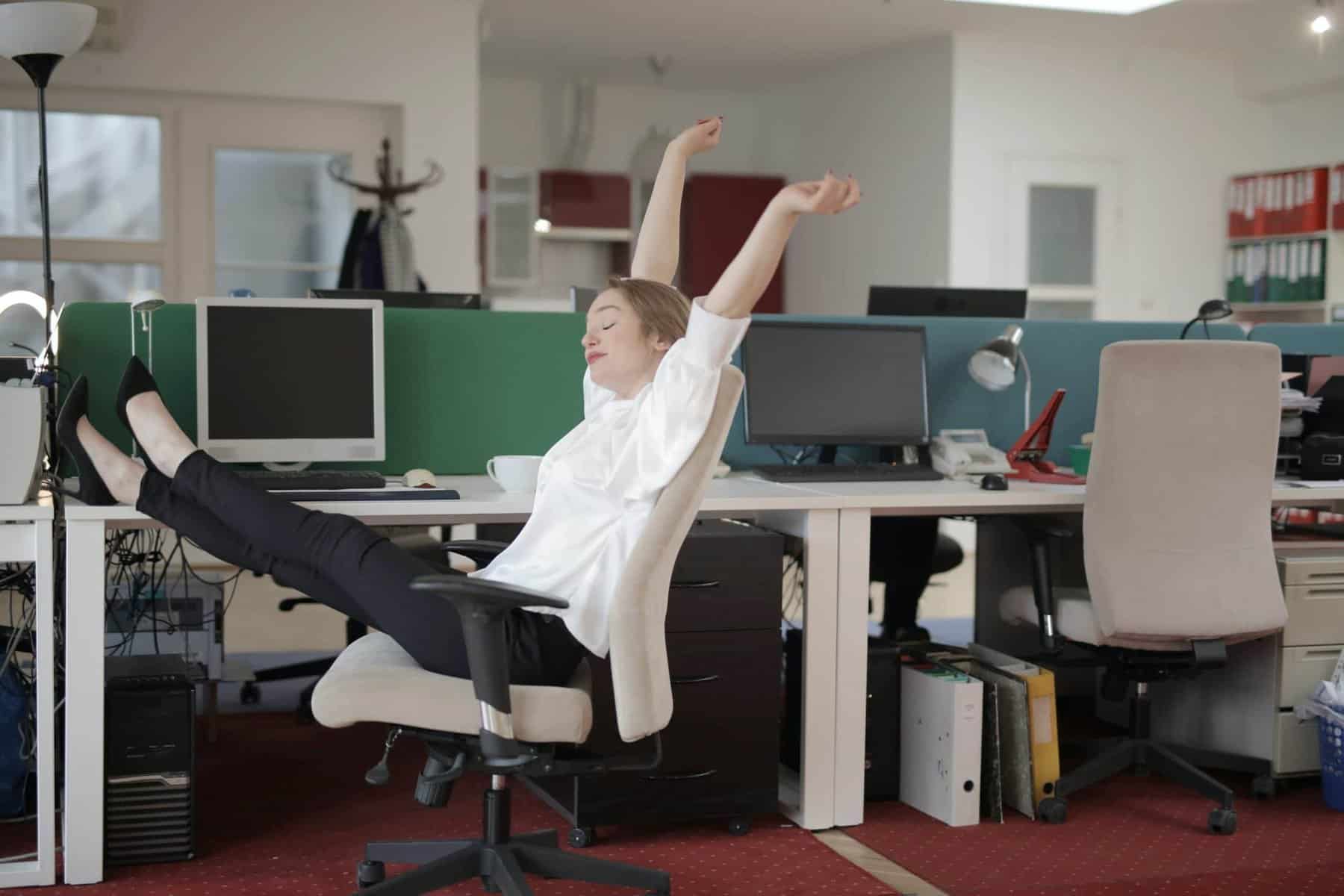 Woman sitting in chair stretching